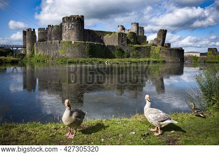 Caerphilly Castle On Sunny Day With Locals Enjoying The View
