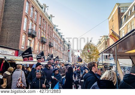 Amsterdam, The Netherlands - November 17, 2018: People Visiting The Albert Cuyp Market, A Street Mar
