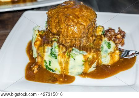 A Dish Of Dutch Meatballs (gehaktballen) Served With Mashed Potatoes