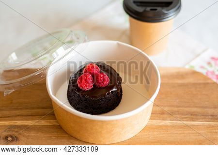 Dessert delivery in a carton box. Chocolate fondant with you. Delivery of chocolate dessert. Fondant