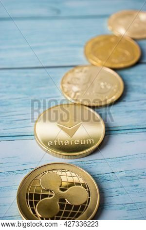 Row Of Different Cryptocurrency Coins In Close-up, Ethereum, Xrp, Bitcoin