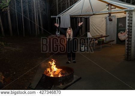 Wyoming, Usa - June 26, 2021: Blonde Woman Wearing Pajamas Starts A Fire In A Designated Fire Ring O