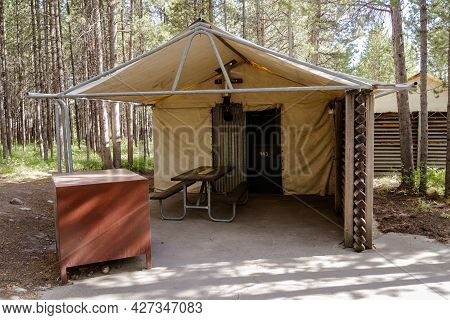 Wyoming, Usa - June 26, 2021: Rustic Tent Cabins At Colter Bay Village, With Picnic Table And A Bear