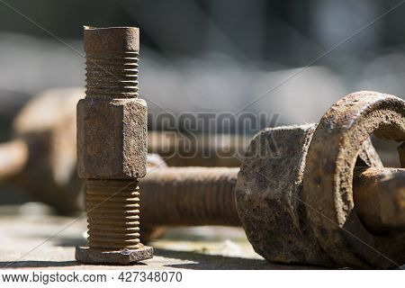 Old Rusty Bolt, Iron Rod With Screw Threads. Rusted Mechanical Components. Threaded Bolt And Nut. Di