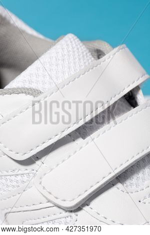 A Close-up Photo Of The Velcro Fastener Of White Sneakers. Childrens Sports Sneakers Made Of Leather