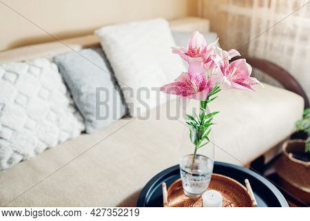 Interior And Home Decor. Fresh Pink Lily Flowers Put In Vase In Living Room By Couch. Bouquet Of Blo