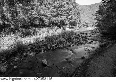 Black And White Photo Of The East Lyn River Flowing Through The Doone Valley At Watersmmeet In Devon