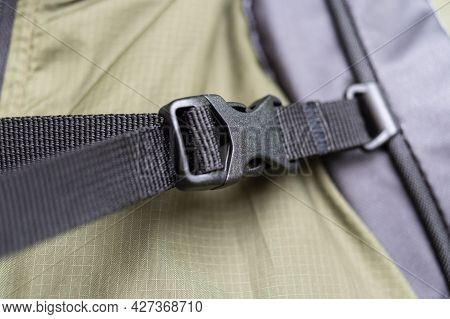 Backpack Chest Buckle. Touring Backpack Strap With Buckle. Black Fastex. Front View.