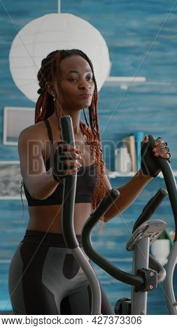Fit Athletic Black Woman Running On Elliptical Bike Watching Wellness Routine Fitness Video On Tv Du