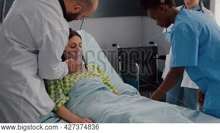 Clinical Team Monitoring Sick Woman Putting Oxigen Mask Analyzing Respiratory Sickness During Corona