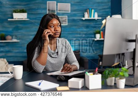 Black Student Sitting At Desk Table In Living Room Working At High School Homework Discussing With C