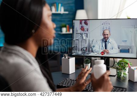 Afro American Patient Discussing Pills Treatment Against Respiratory Sickness With Therapist During 