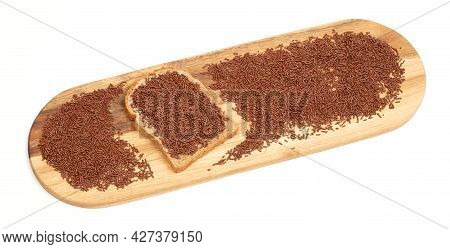 Typical Dutch Chocolate Sprinkles (hagelslag) On A Slice Of Bread, Served On A Wooden Plate, Isolate