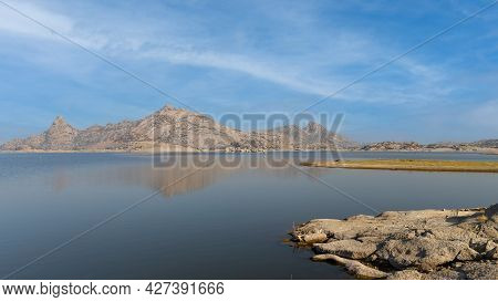 View Of Jawai Dam With Water And Rocky Mountains At Jawai In Rajasthan India
