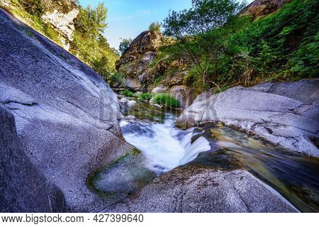 Stream Of Water Between Large Eroded Rocks. Navacerrada.