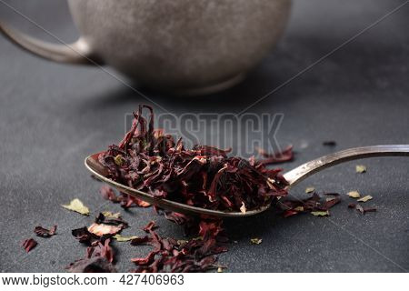 Dry Hibiscus Tea In A Spoon. Tea Concept