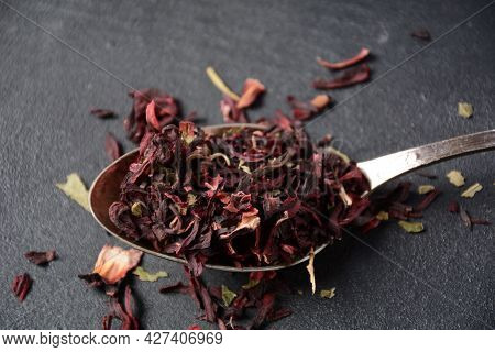 Dry Hibiscus Tea In A Spoon. Tea Concept