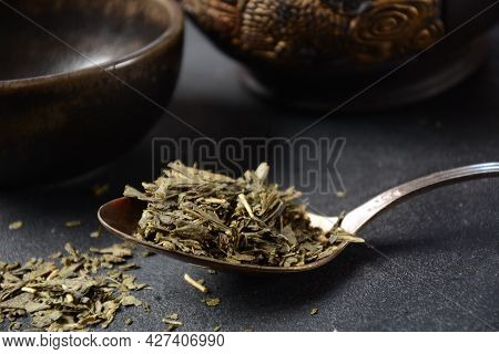 Dry Bancha Green Tea In A Spoon. Japanese Tea