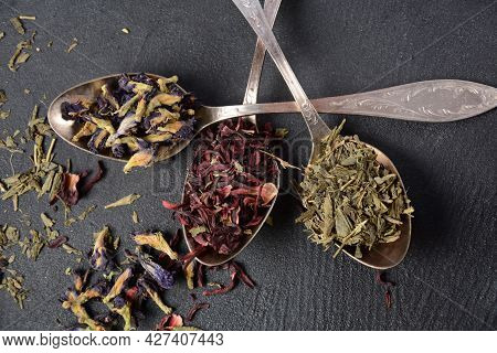 Various Kinds Of Dry Tea Bancha Green, Hibiscus, Butterfly Pea Flower Tea In Spoons On The Table