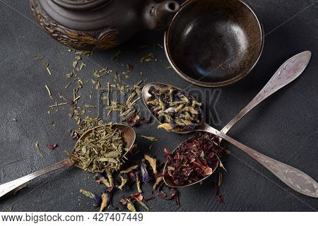 Various Kinds Of Dry Tea Bancha Green, Hibiscus, Butterfly Pea Flower Tea In Spoons On The Table