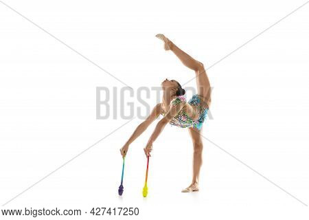 One Female Rhythmic Gymnast With Clubs In Motion And Action Isolated On White Background.
