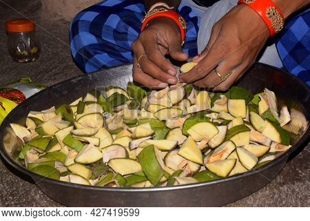 Hands Of Indian Rural Woman Cutting Raw Mangoes, Mango Pickle Process