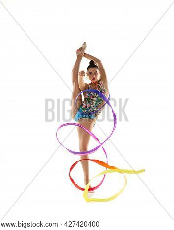 Ribbon Exercise. One Young Beautiful Female Rhythmic Gymnast Posing Isolated Over White Studio Backg
