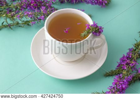Cup Of Tea With Willow-herb On Blue Background.herbal Tea From Fermented Kipreya Leaves. Traditional