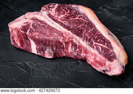 Dry-aged Raw T-bone Or Porterhouse Beef Marbled Meat Prime Steak Set, On Black Stone Background