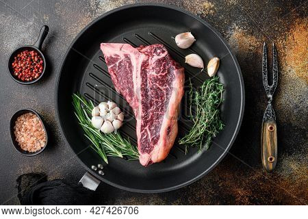 Cooking Meat Background. Raw Aged Beef T-bone Steak, With Spices And Herbs For Grill Set, On Frying 