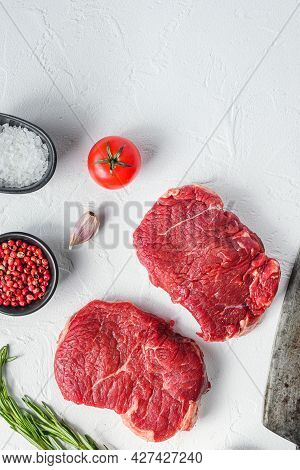 Raw Rumpsteak, Farm Beef Meat With Seasonings, Rosemary, Garlic And Butcher Cleaver. White Textured 