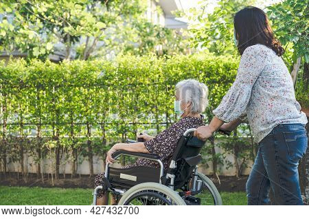 Doctor Help And Care Asian Senior Or Elderly Old Lady Woman Patient Sitting On Wheelchair At Park In