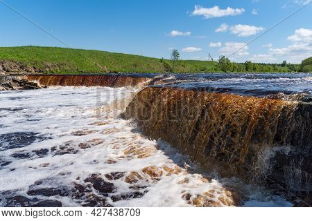 Waterfall On The Tosno River With Rapids And Stony Shore.  Sablino. Leningrad Region. Russia.