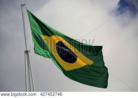 Salvador, Bahia, Brazil - July 20, 2021: Flag Of Brazil Is Seen On The Pole Of A Supermarket In The 