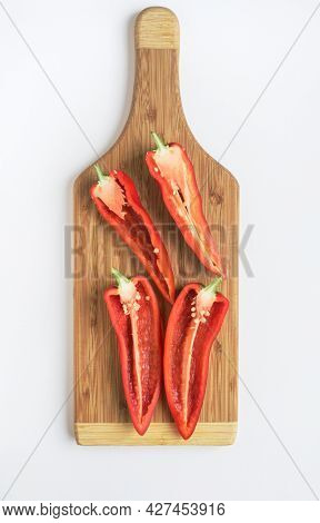 Split Red Peppers on Wooden Cutting Board