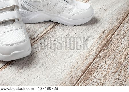 White Sneakers On A Light Background. Side View Of A Pair Of Fashionable Childrens Leather Fabric-st