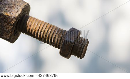 Old Rusty Bolt, Iron Rod With Screw Threads. Rusted Mechanical Components. Threaded Bolt And Nut Iso