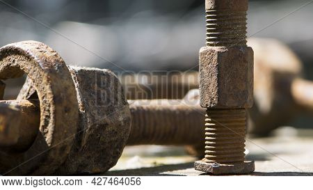 Old Rusty Bolt, Iron Rod With Screw Threads. Rusted Mechanical Components. Threaded Bolt And Nut. Di