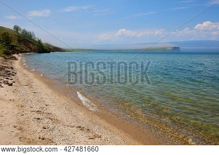 The Shore Of Lake Baikal On A Summer Day. Calm, Clear, Clear Water. Beautiful Summer Landscape. Fog 