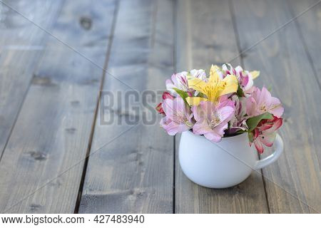 Multicolored Flowers In White Mug With Copy Space. Multicolored Alstroemerias, Pink, Yellow, Purple,