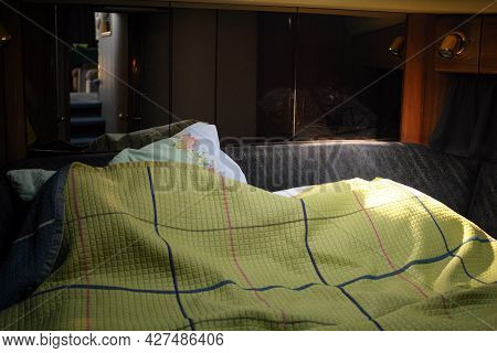 Morning Light In A Yacht Stateroom And Unmade Bed