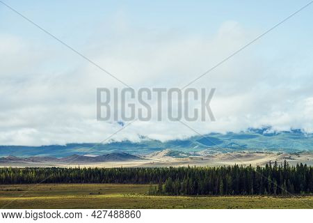 Beautiful Layered Landscape With Hills And Forest In Mountain Valley And Low Clouds In Cloudy Sky. L