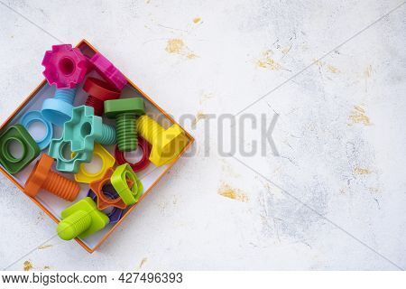 Educational Constructor For Children, Nuts And Bolts In The Form Of Geometric Shapes. Mock Up Backgr