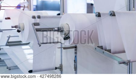 non woven material on automatic machine for the manufacture of medical masks with nanofiber. Coronavirus and Covid-19 Protection