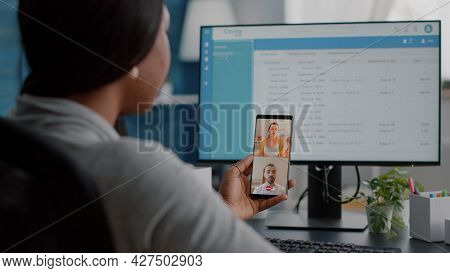 African Student Holding Phone In Hands Discussing With Team Marketing Online School Course During Vi