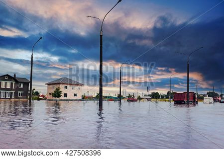 Bad Extreme Heavy Rain Storm Weather. Flooded Streets Of The Neighborhood. A Flooded Road Junction W