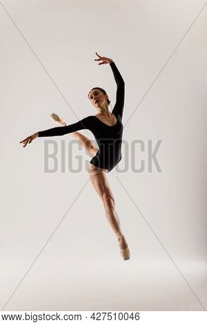 Portarit Of Sensual Professional Caucasian Callet Dancer In Body Suit And Pointes Shoes On White.