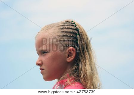 Ragazza con trecce su una spiaggia