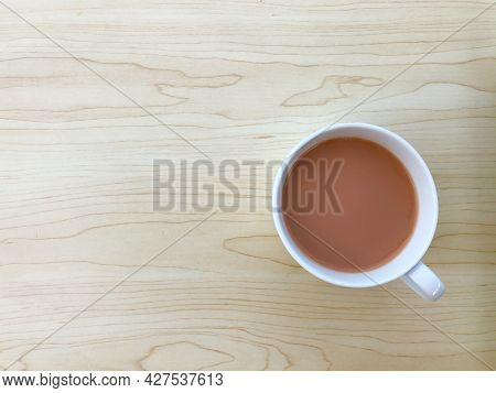 Top View Of Hot Milk Tea Or Teh Tarik In A White Cup. Copy Space