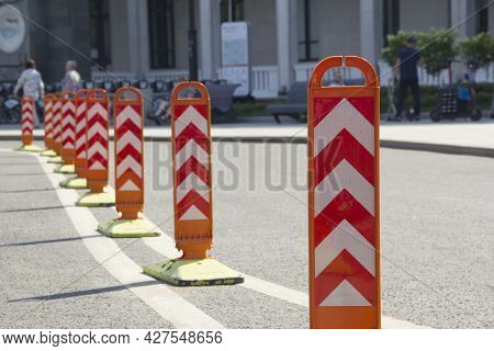 Orange Road Dividers. Curved Line Of Dividing Posts On The Double Road Marking Line.
